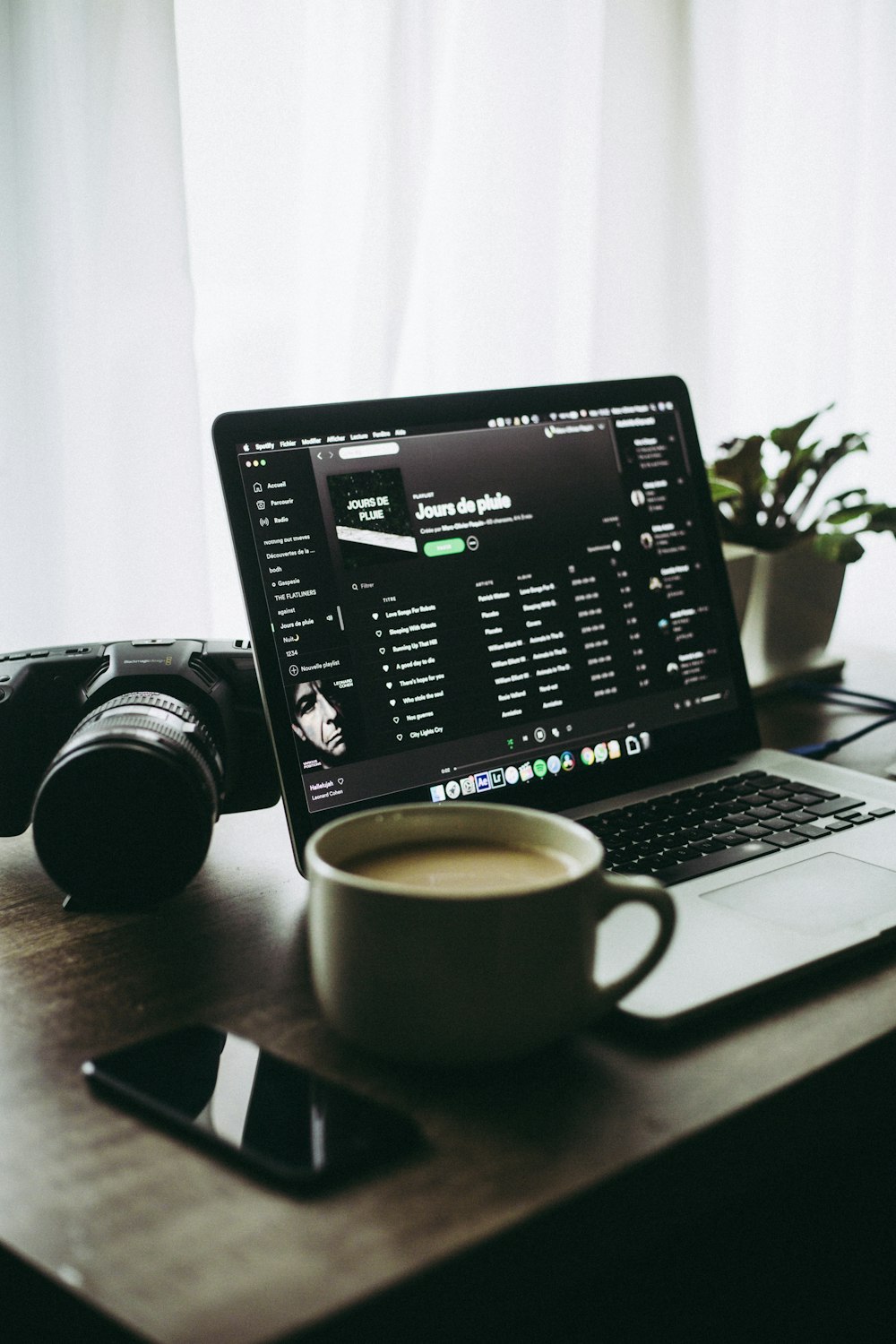 black and silver laptop computer beside white ceramic mug