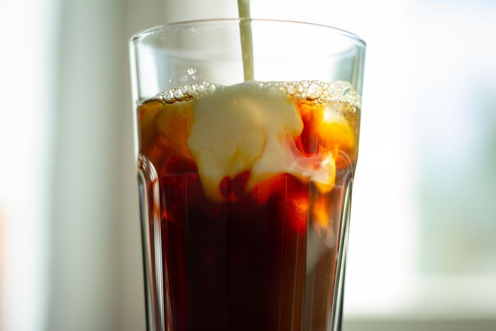 clear drinking glass with brown liquid