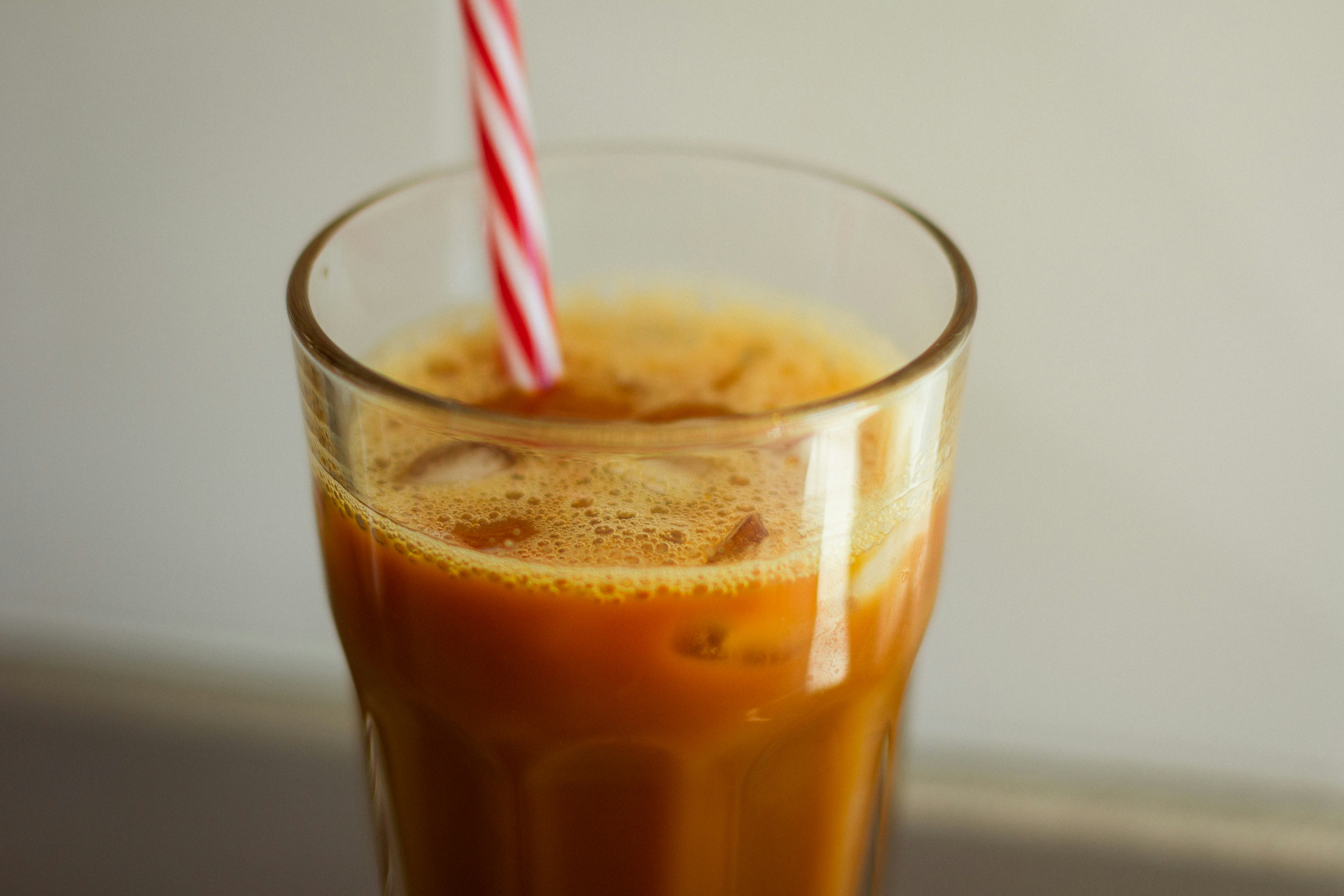 clear drinking glass with brown liquid