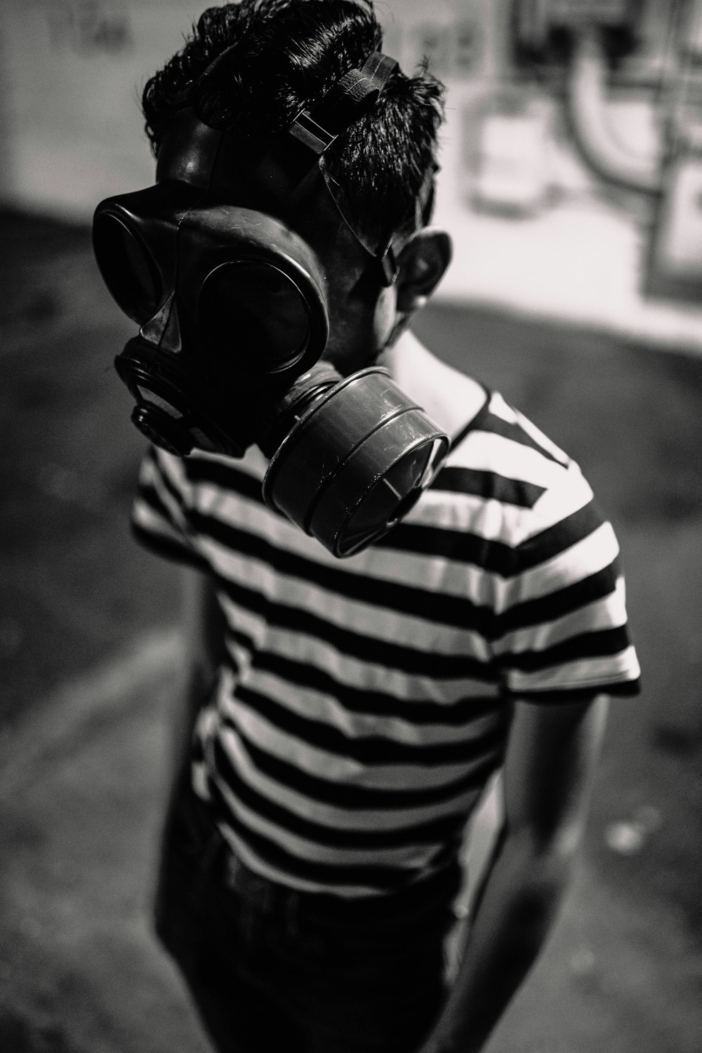 person in black and white stripe shirt wearing black gas mask