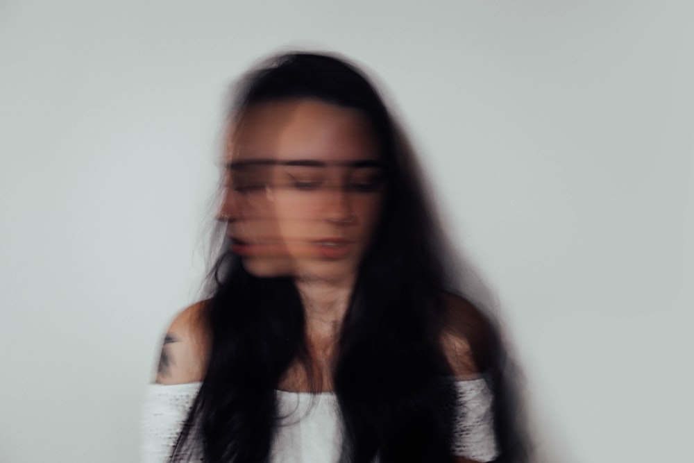 a blurry photo of a woman with glasses