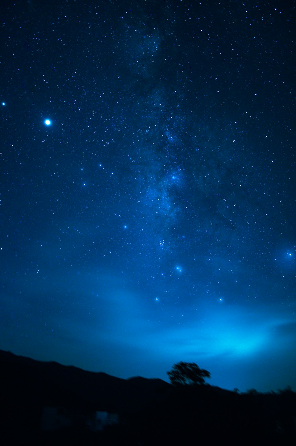 silhouette di montagna sotto il cielo blu durante la notte