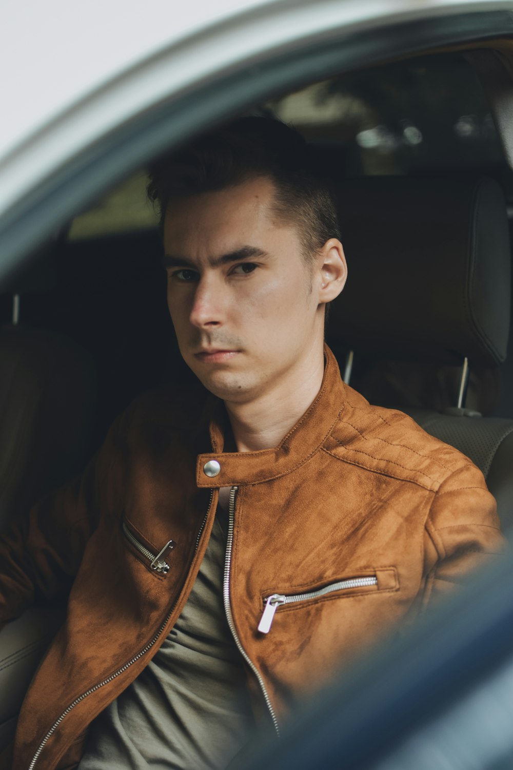 man in brown leather jacket