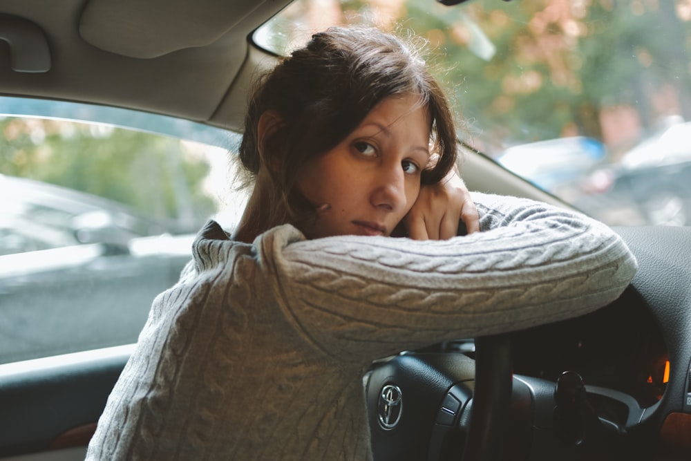 woman in brown scarf inside car