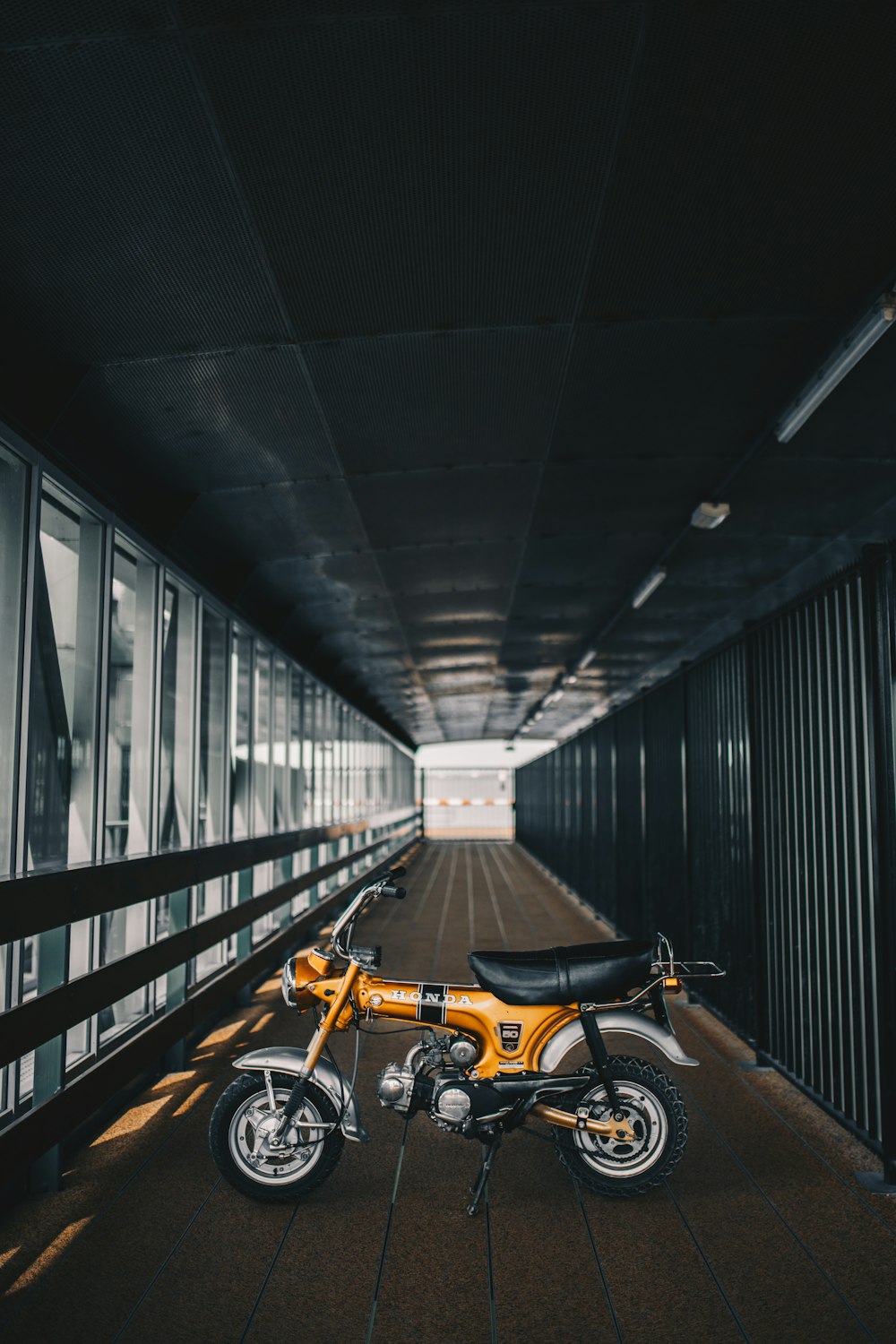 yellow and black motorcycle parked on tunnel