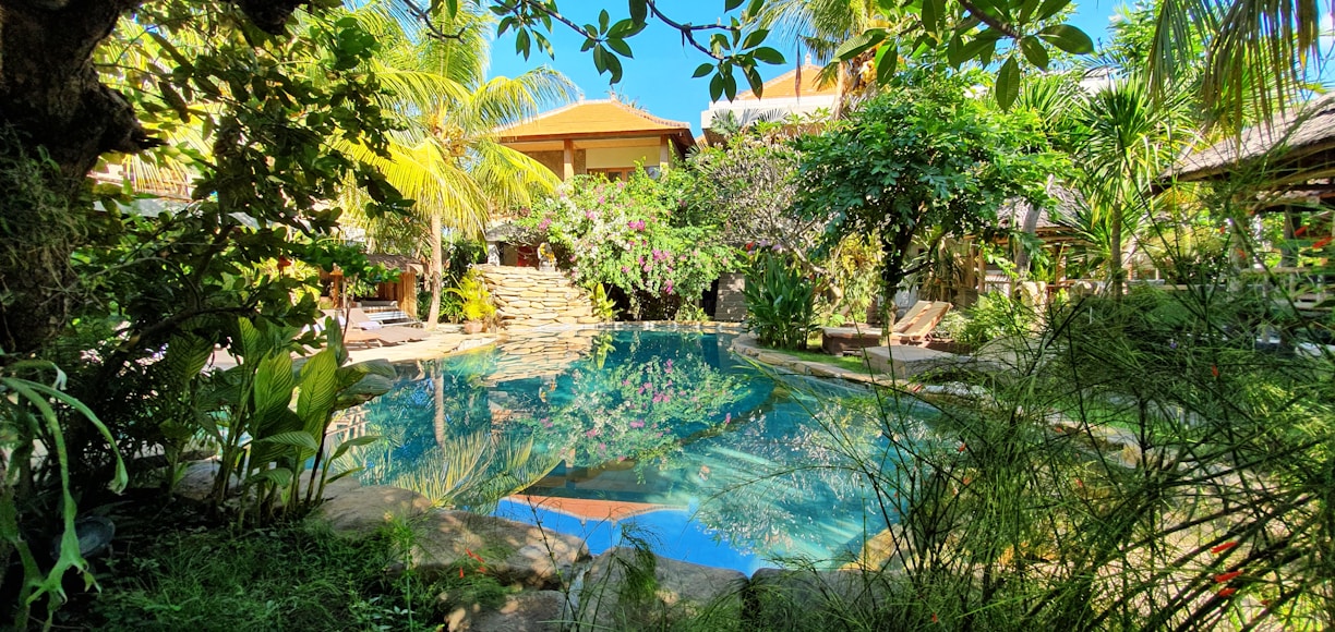 A serene villa with a private pool surrounded by lush greenery.