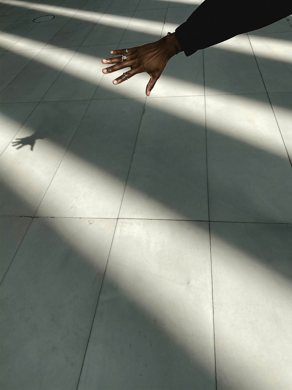 person standing on white ceramic floor tiles