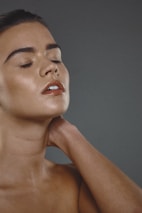 A peaceful scene of someone applying Lakshmye balm to their temples after a long day.