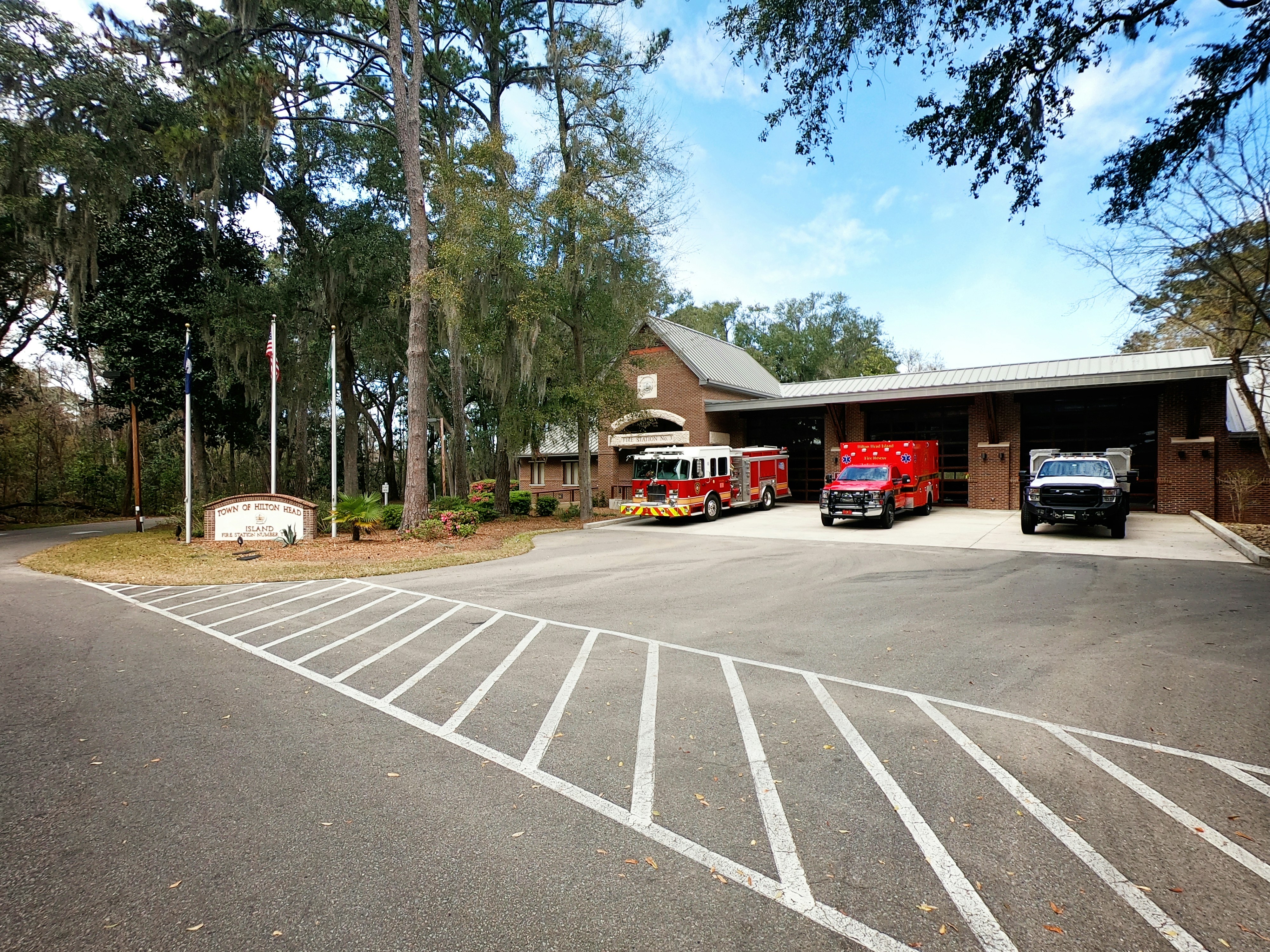 two fire trucks parked in front of a fire station