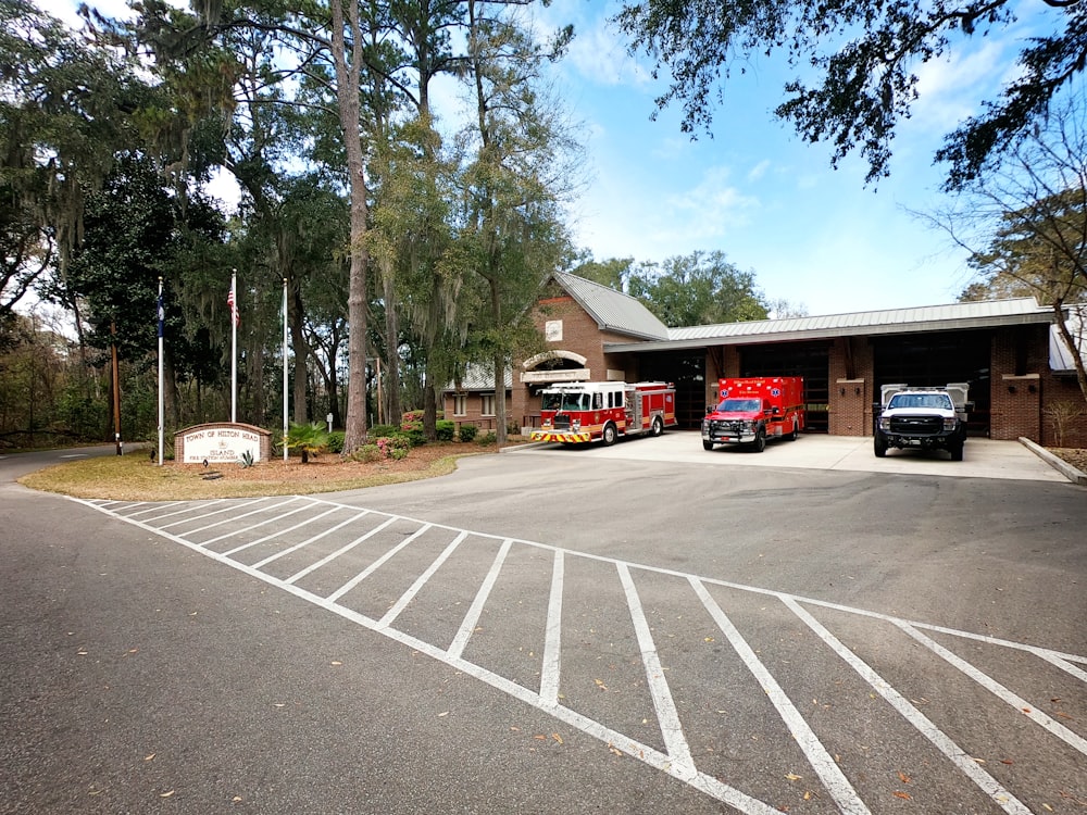 two fire trucks parked in front of a fire station