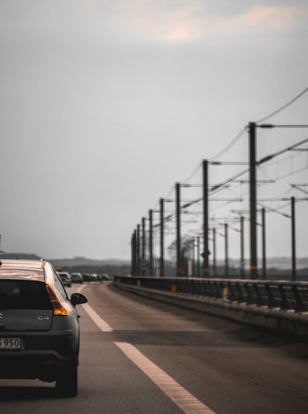 a car driving down a highway next to power lines