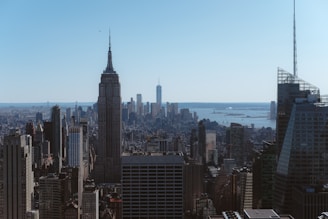 Panoramic view of Empire Tower’s high-rise facade against the sea and city skyline.