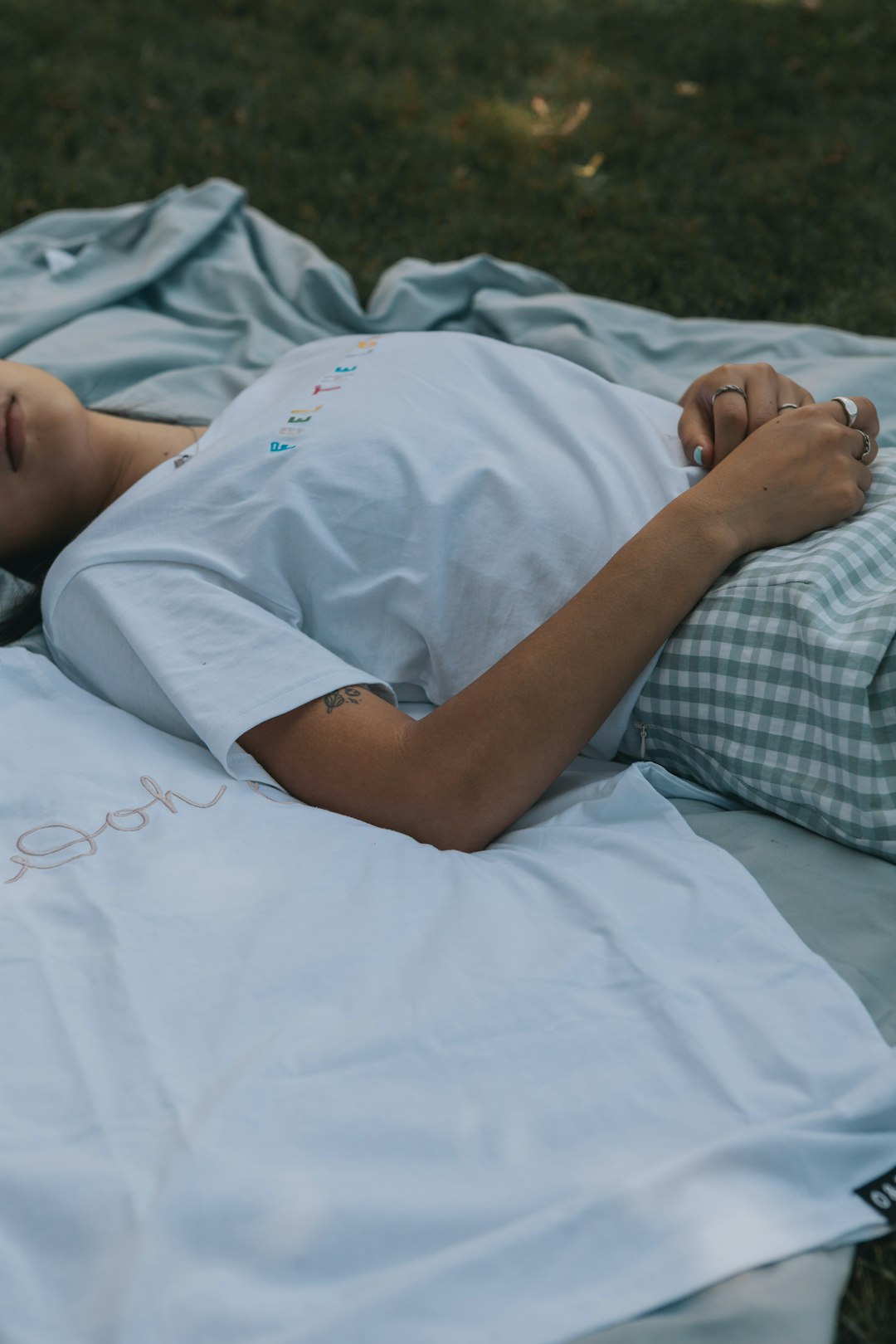 woman in white t-shirt lying on bed