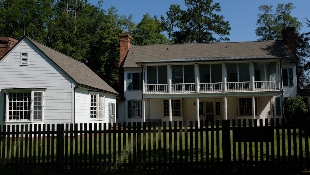 white and brown wooden house near green trees during daytime