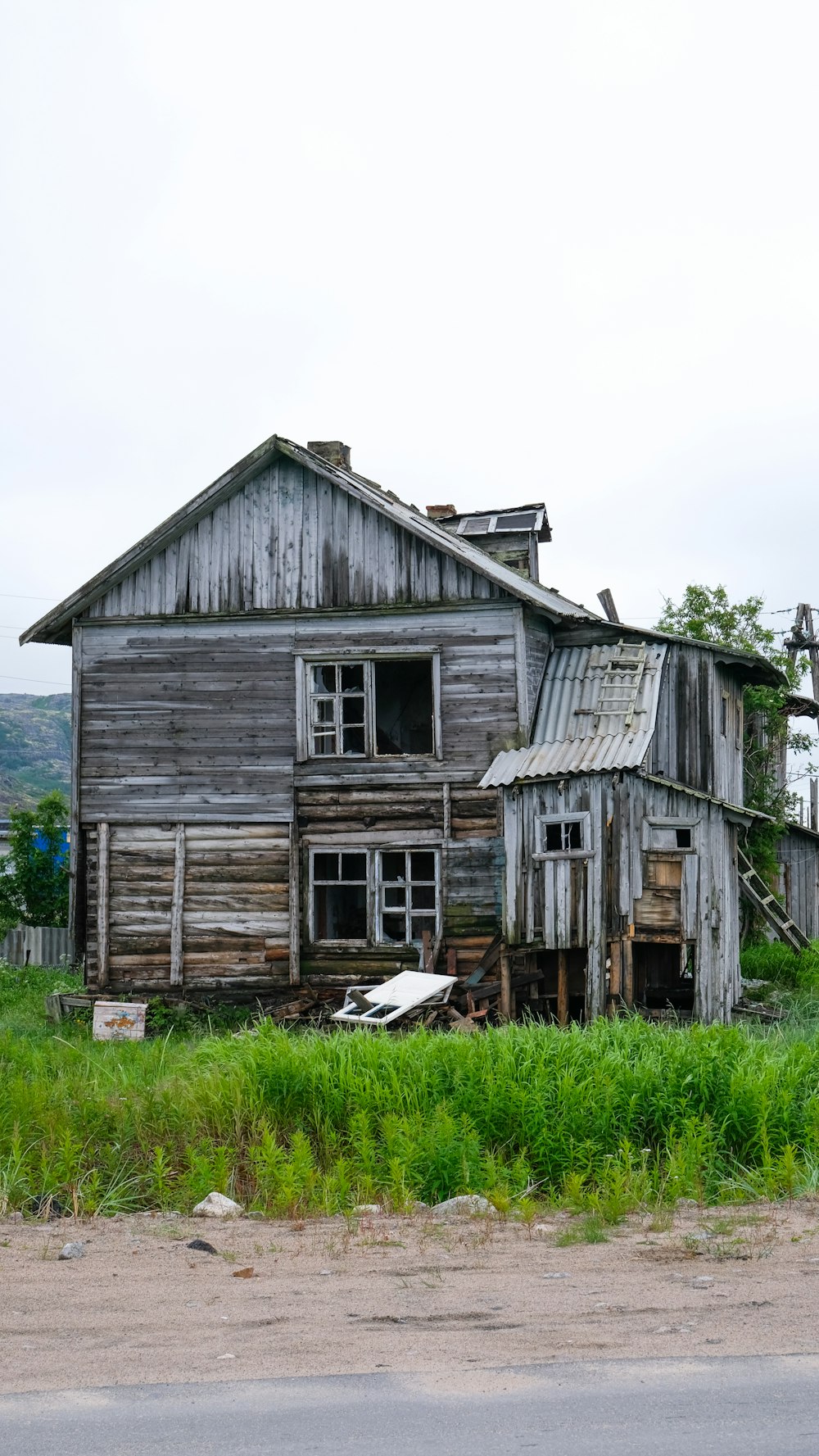 brown wooden house on green grass field during daytime