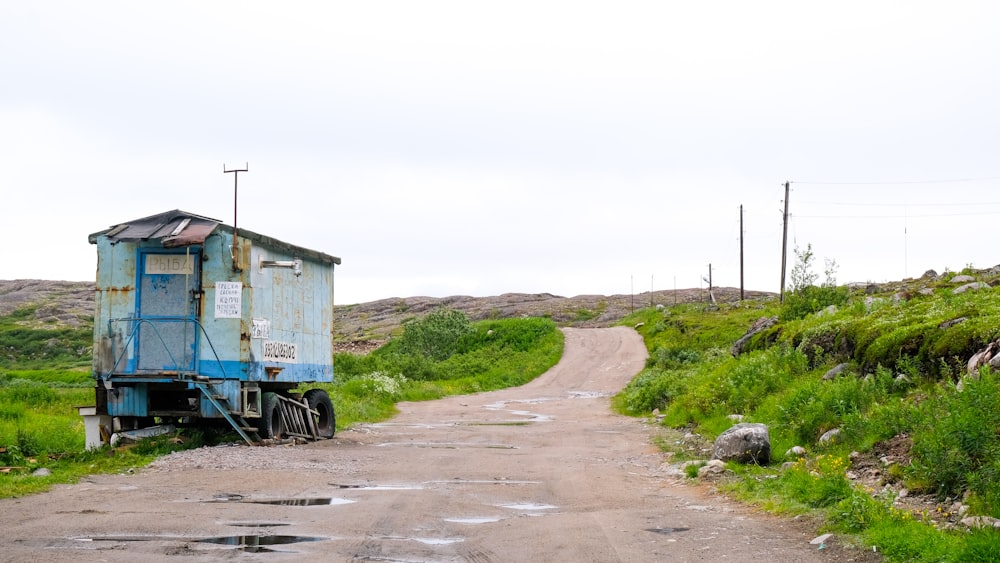 blue and white truck on road during daytime