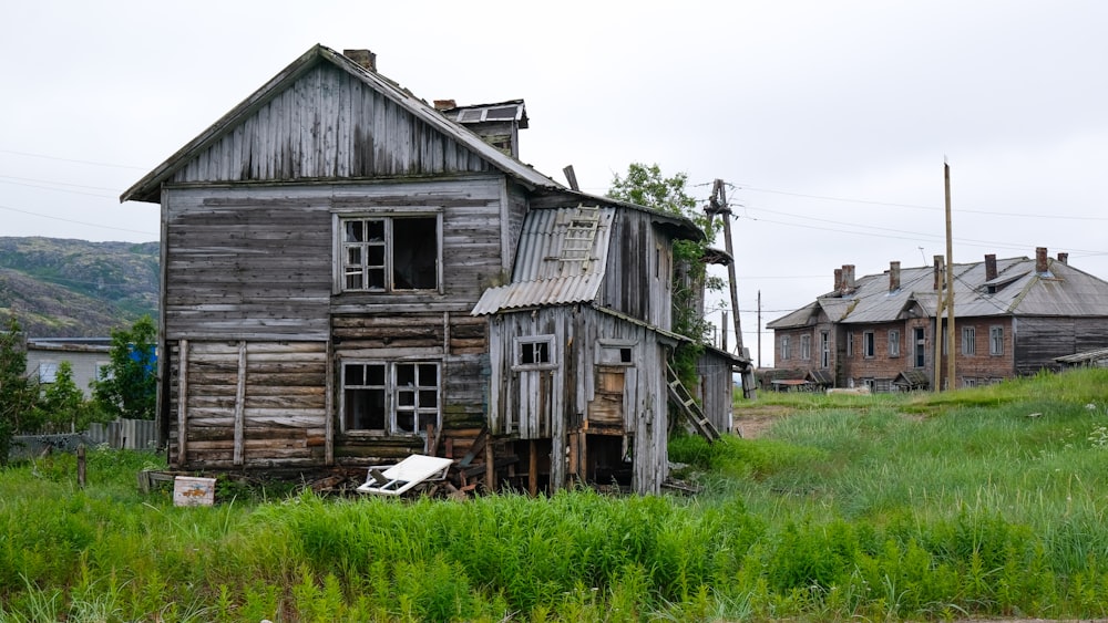 brown wooden house on green grass field during daytime