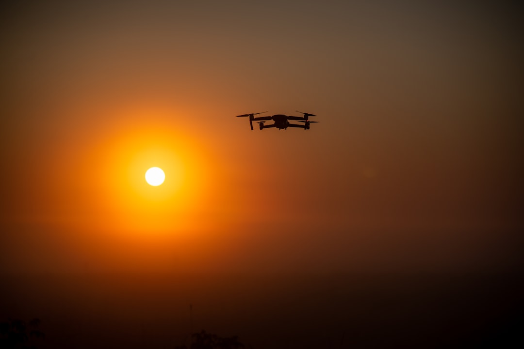 silhouette of airplane flying during sunset