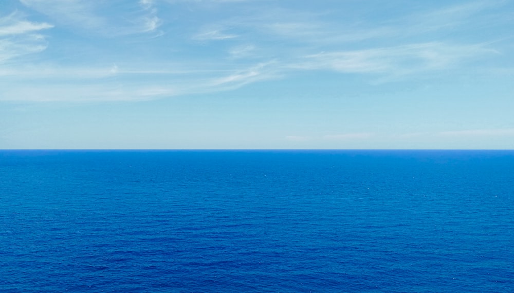 blue ocean under blue sky during daytime