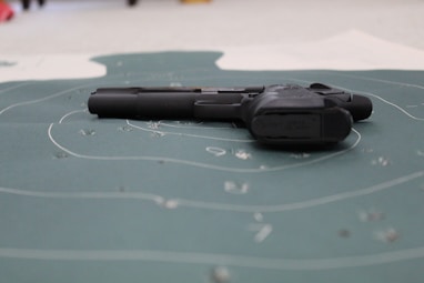 A close-up of a competitor aiming their firearm at a target.
