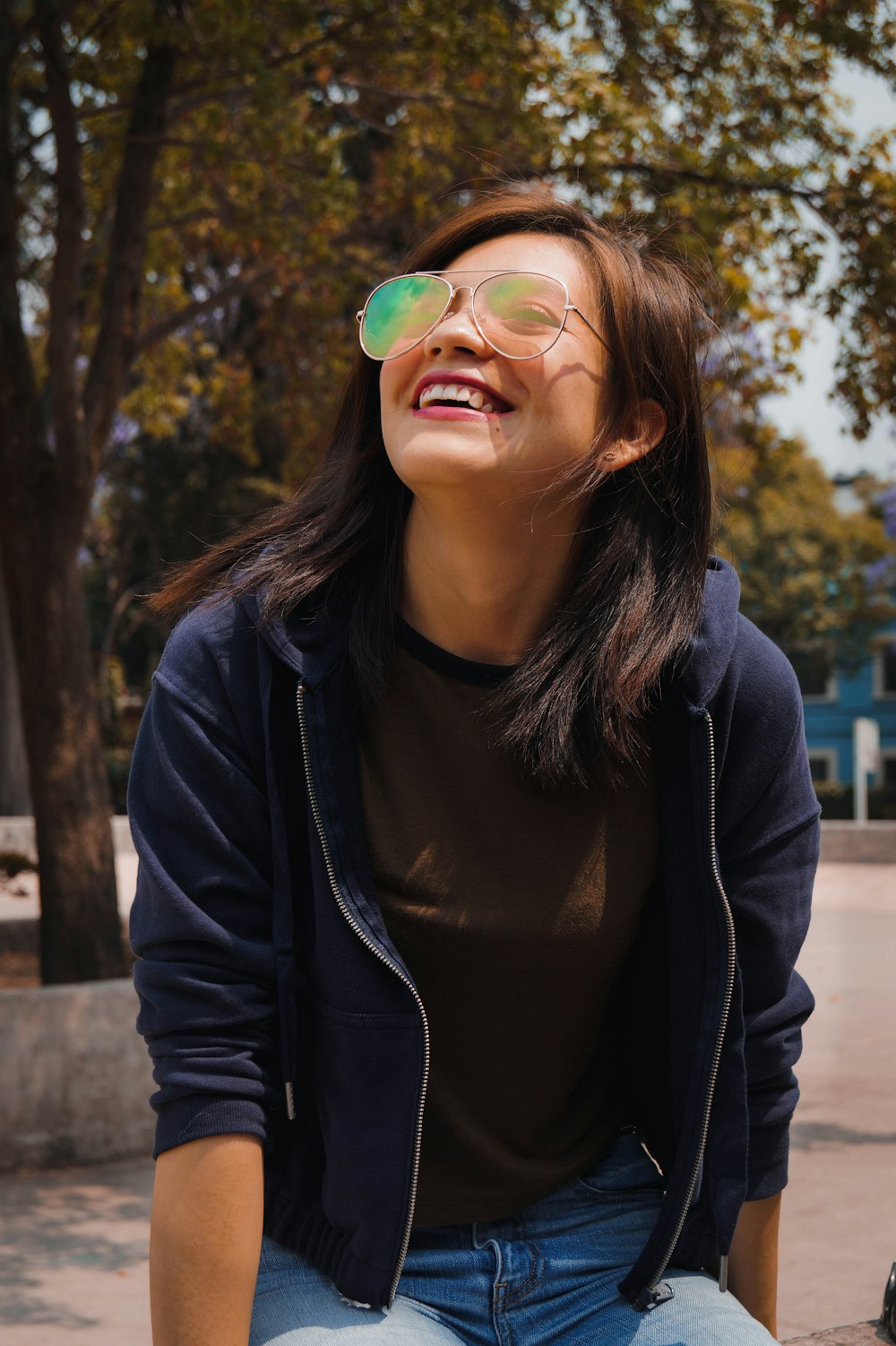 woman in black jacket with green and blue eye mask