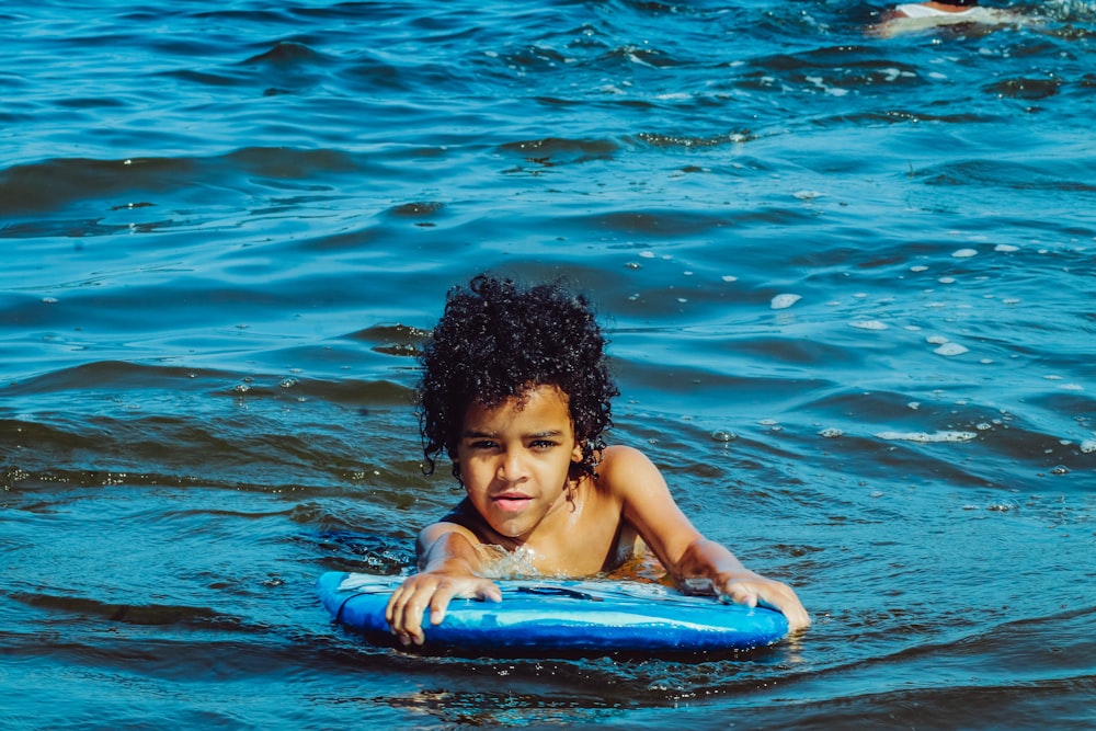 woman in blue swimming pool during daytime