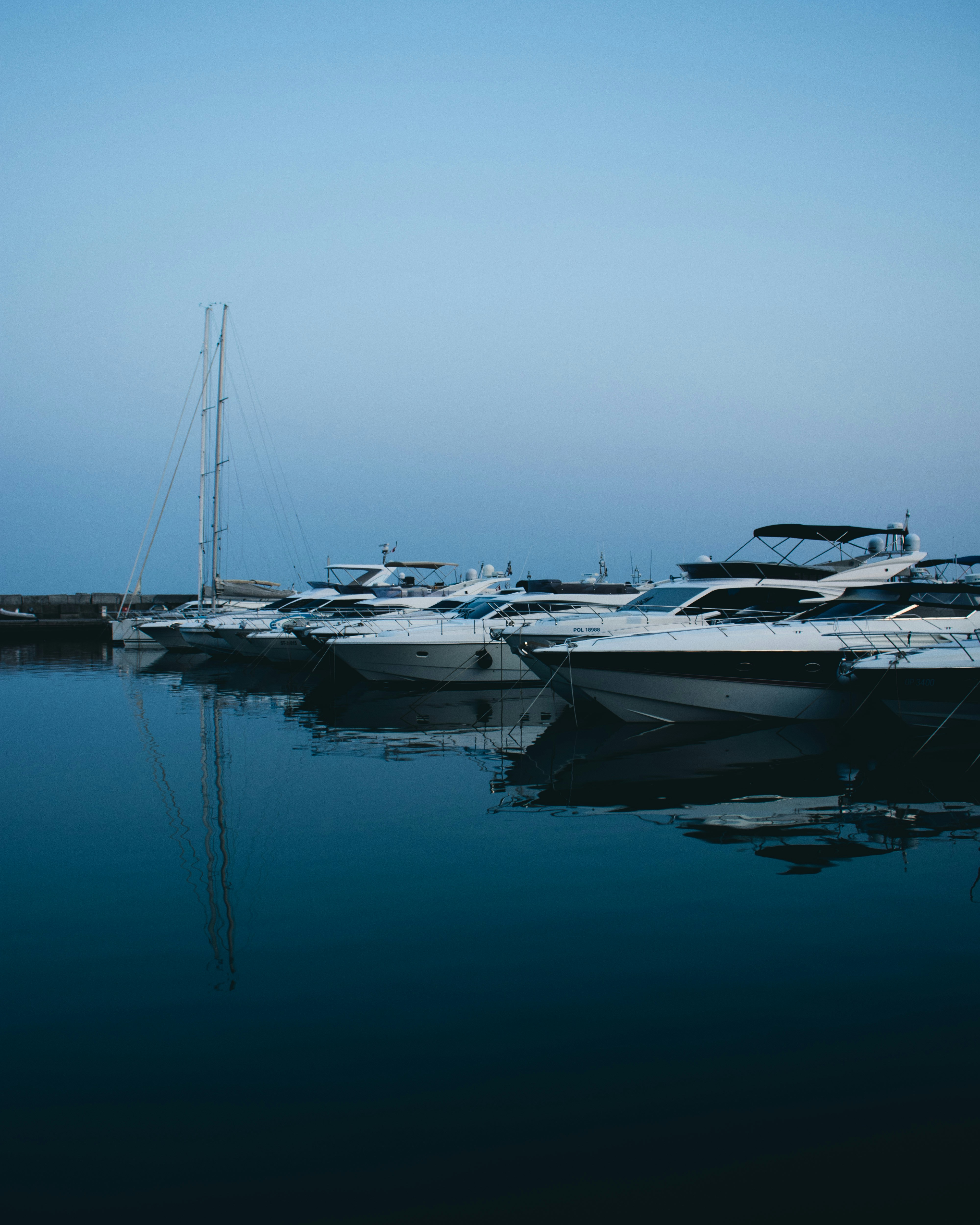 white and gray boats on body of water during daytime