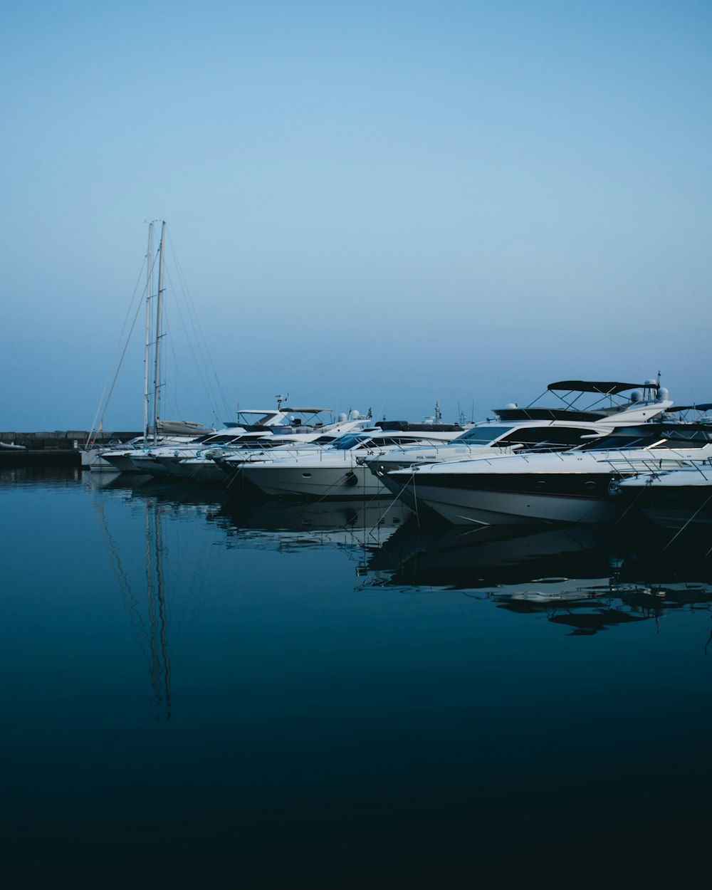 white and gray boats on body of water during daytime