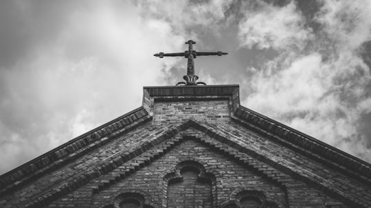 grayscale photo of cross on top of building in Friedrichsdorf Germany