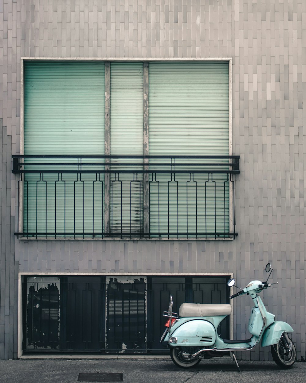 white and black motorcycle parked beside brown building