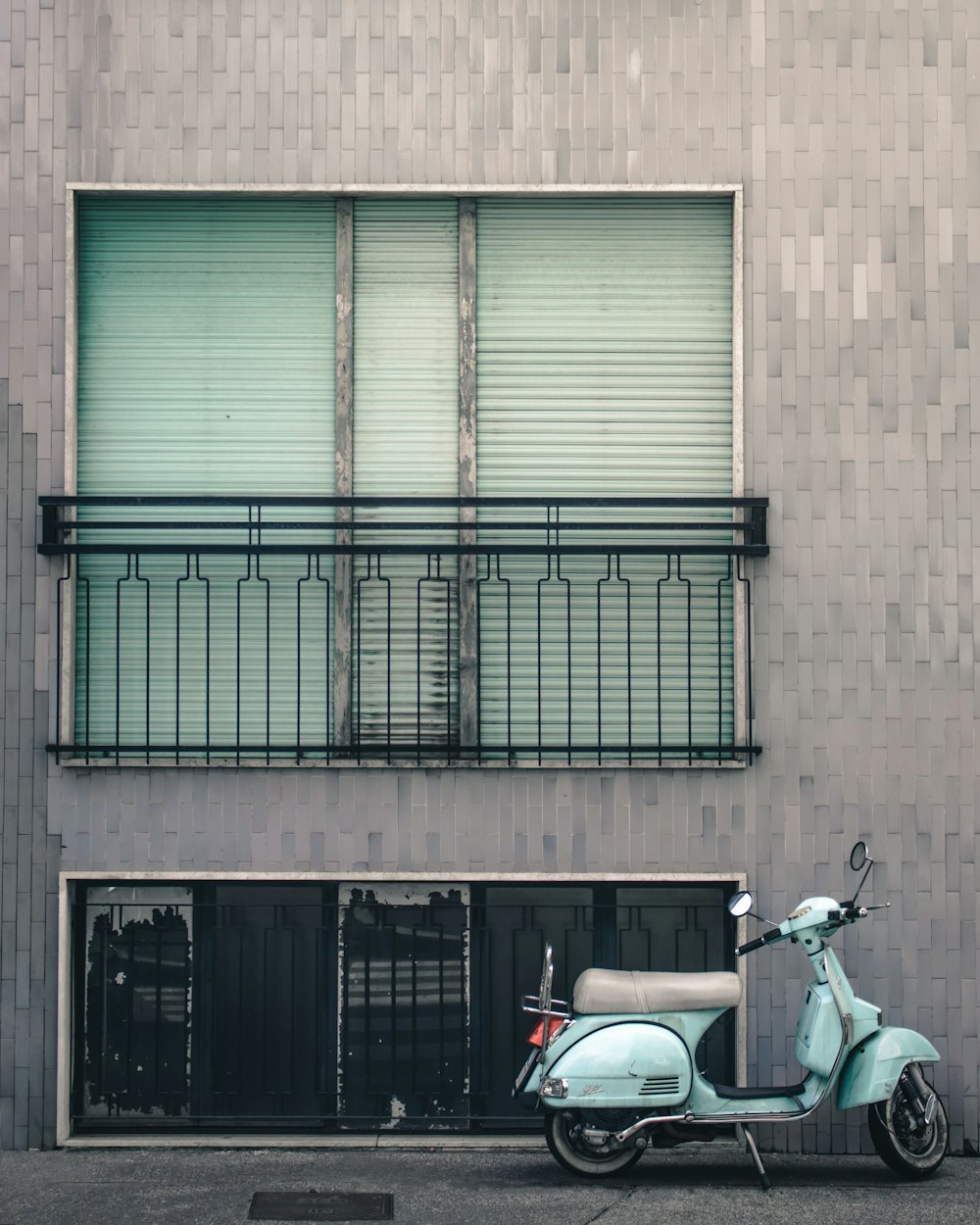 Moto blanche et noire garée à côté d’un bâtiment brun