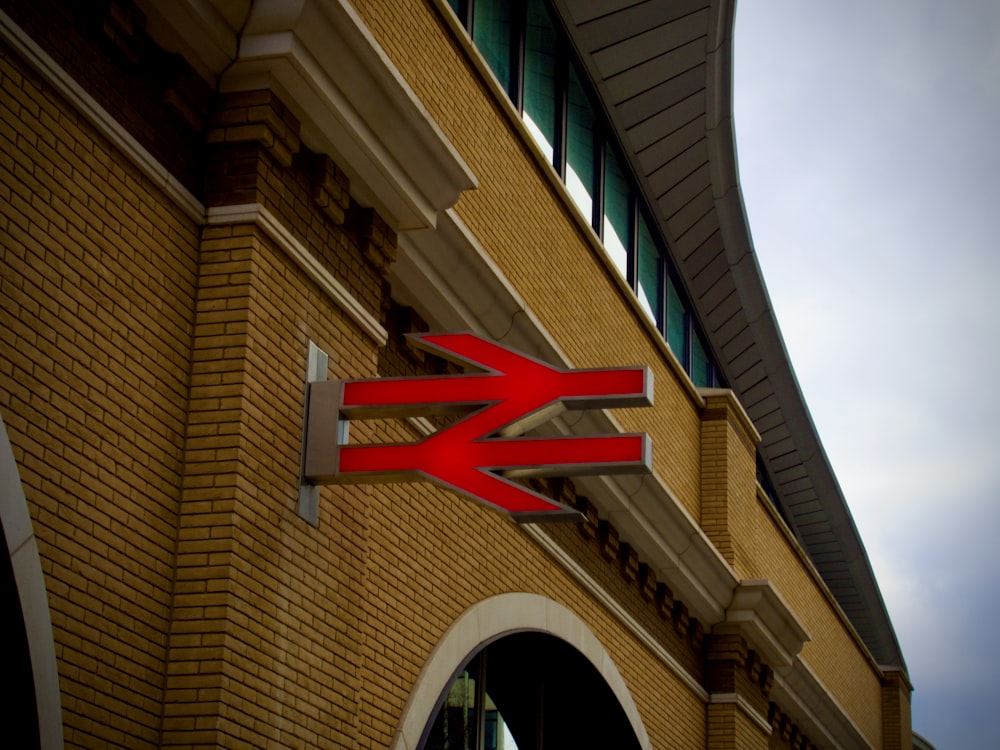 brown concrete building with red and white flag