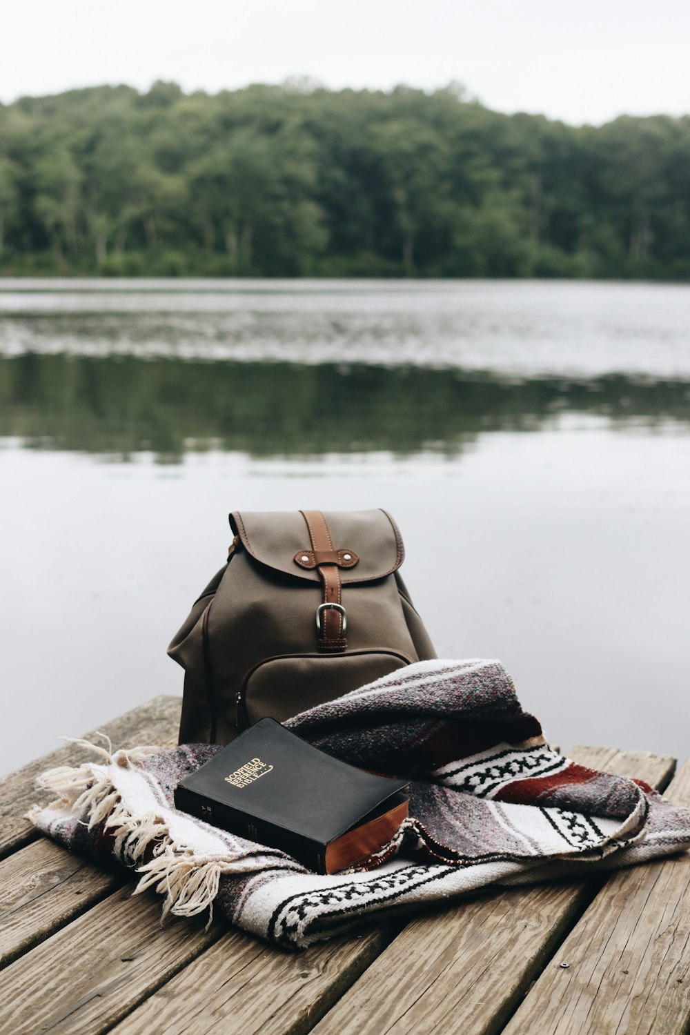 brown leather backpack on brown textile