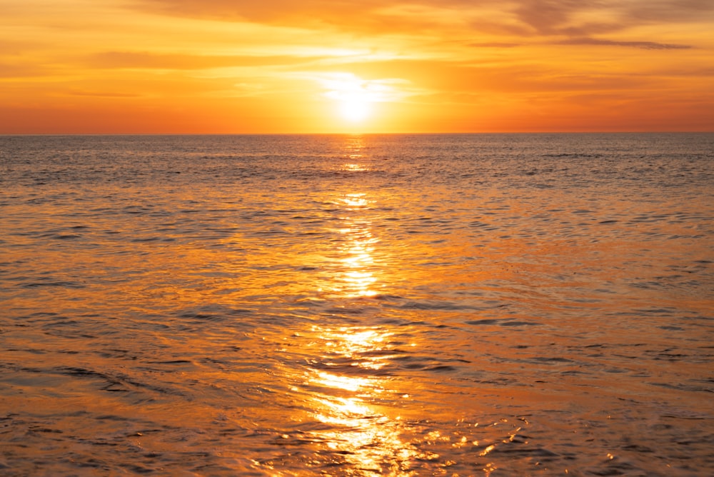 body of water during sunset