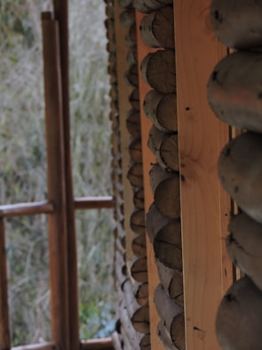 Close-up of handcrafted wooden details in a bioconstruction lodging room surrounded by nature