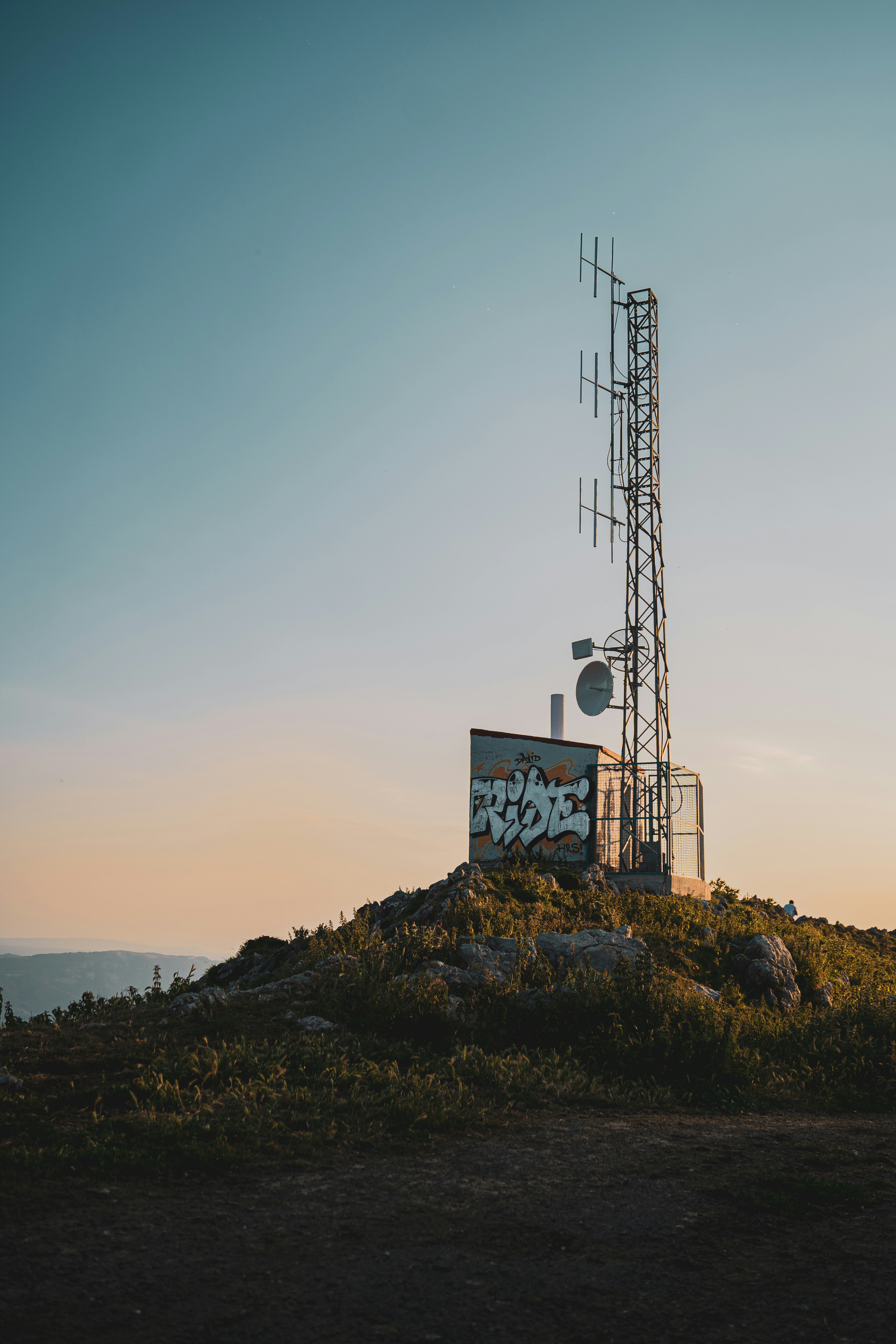 white and blue signage on top of mountain during daytime