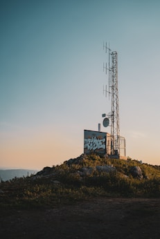white and blue signage on top of mountain during daytime