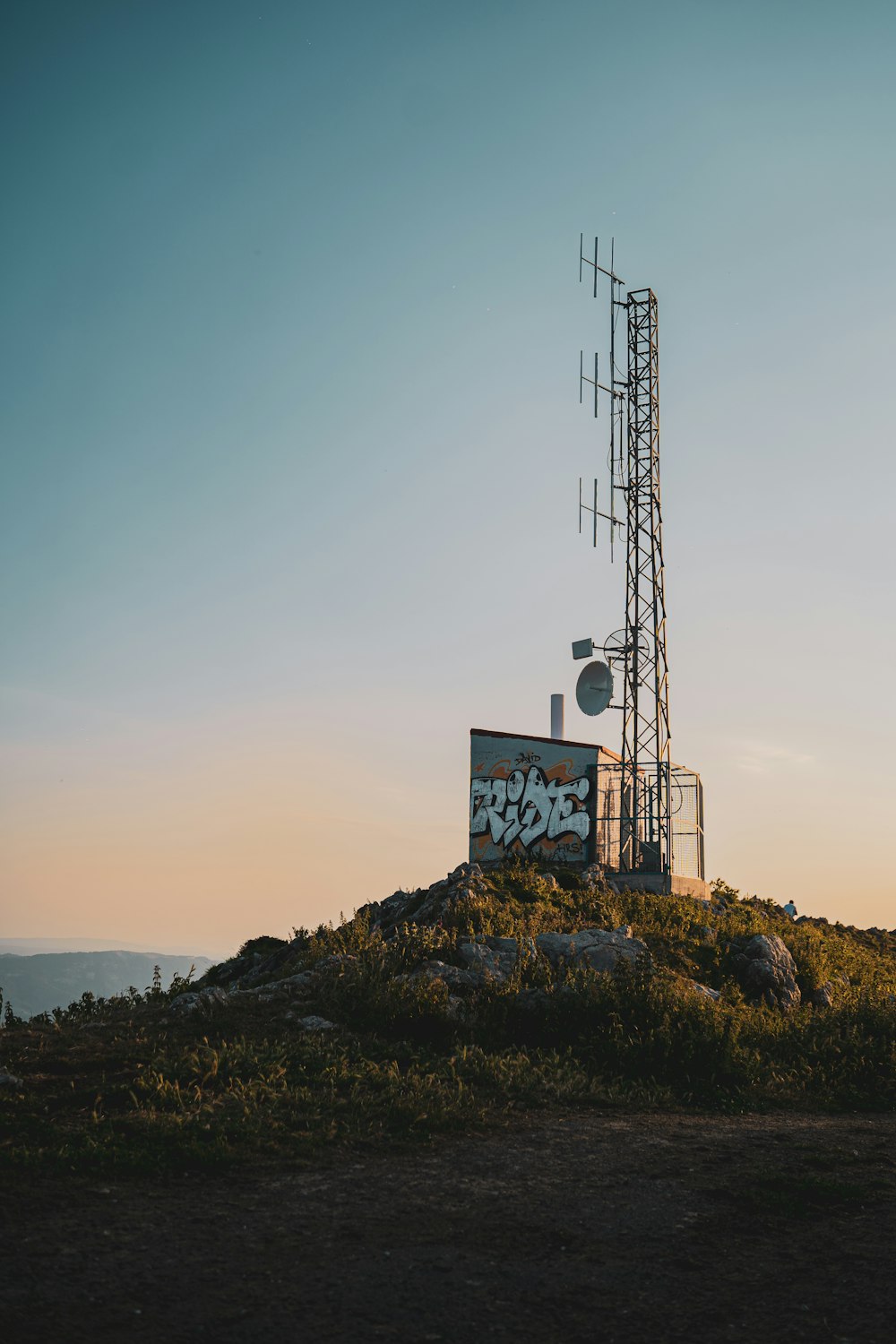 white and blue signage on top of mountain during daytime