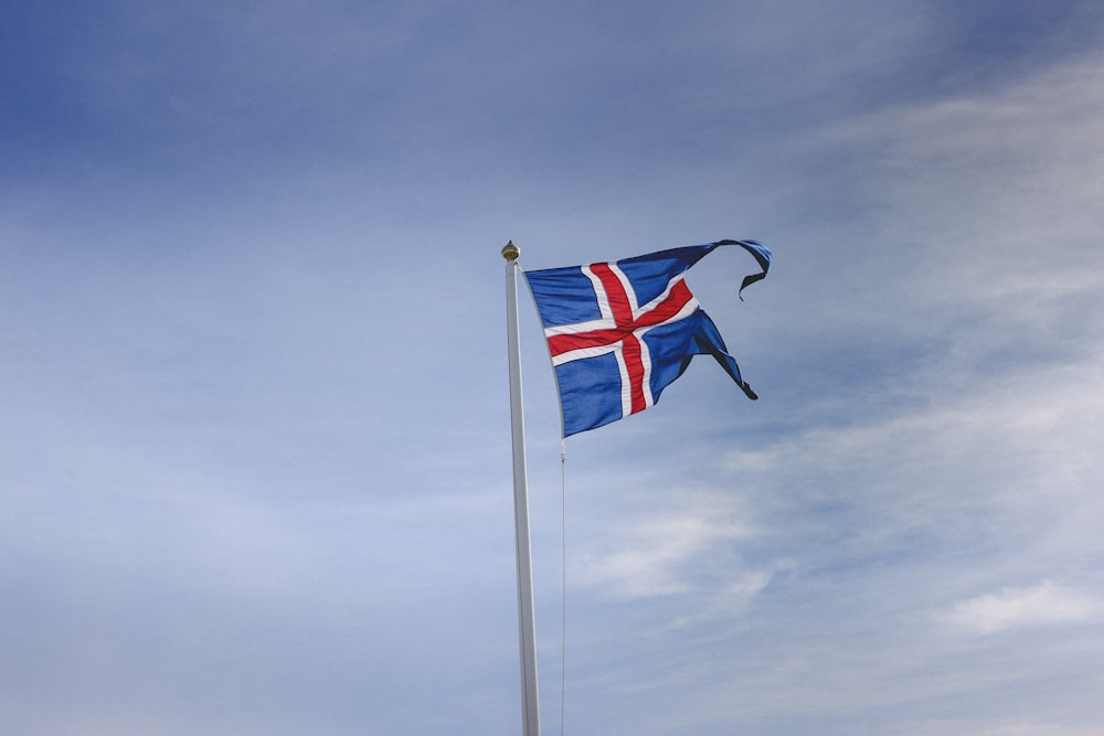 flag of us a on pole under blue sky