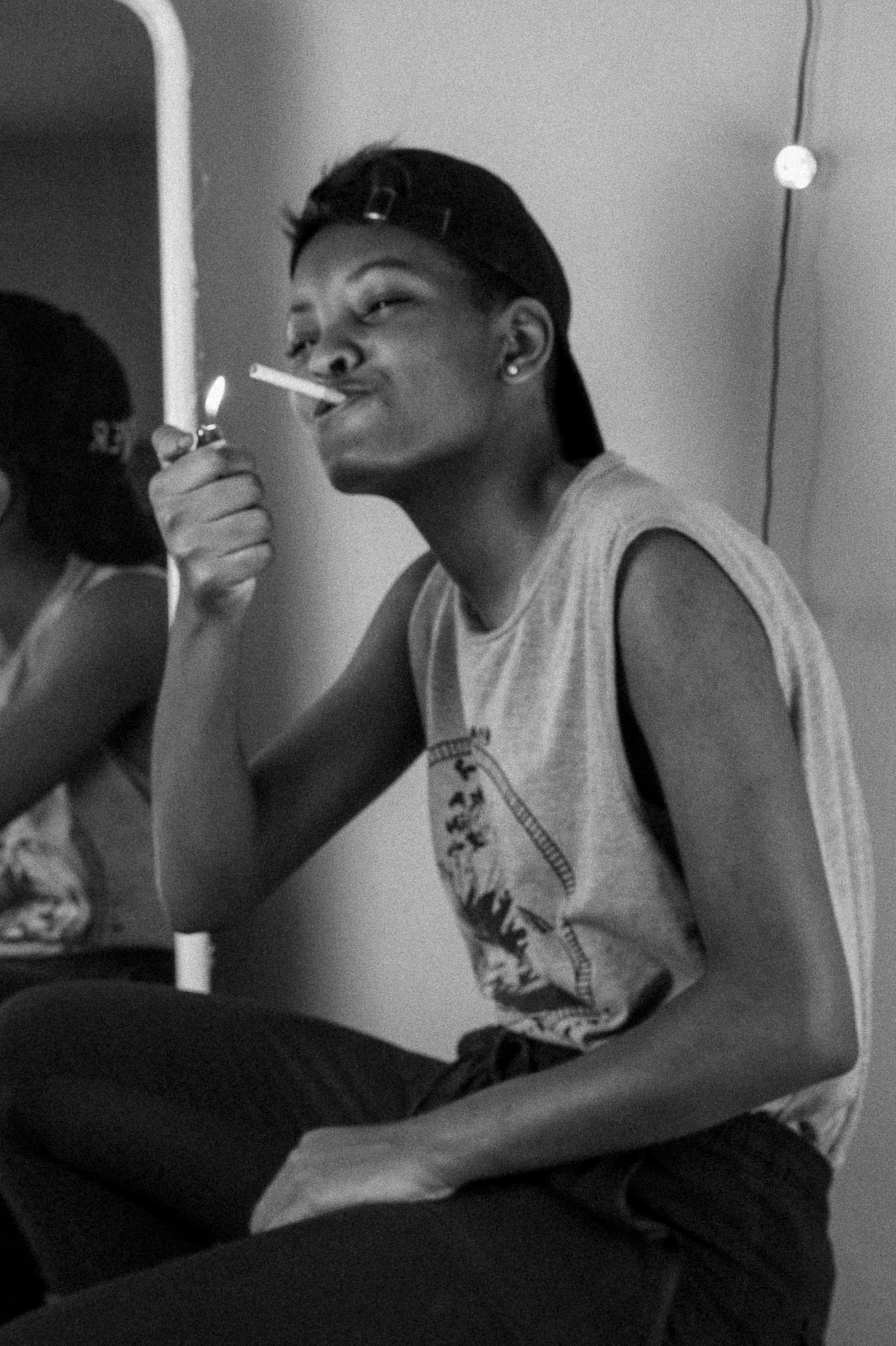 woman in tank top smoking cigarette