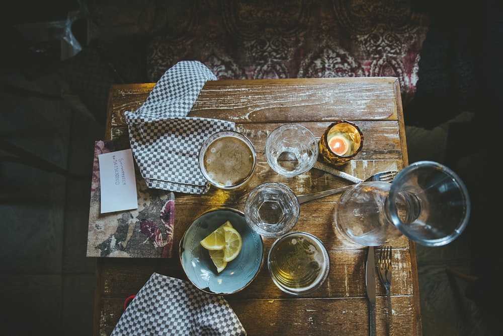 clear drinking glass on blue and white checkered table cloth