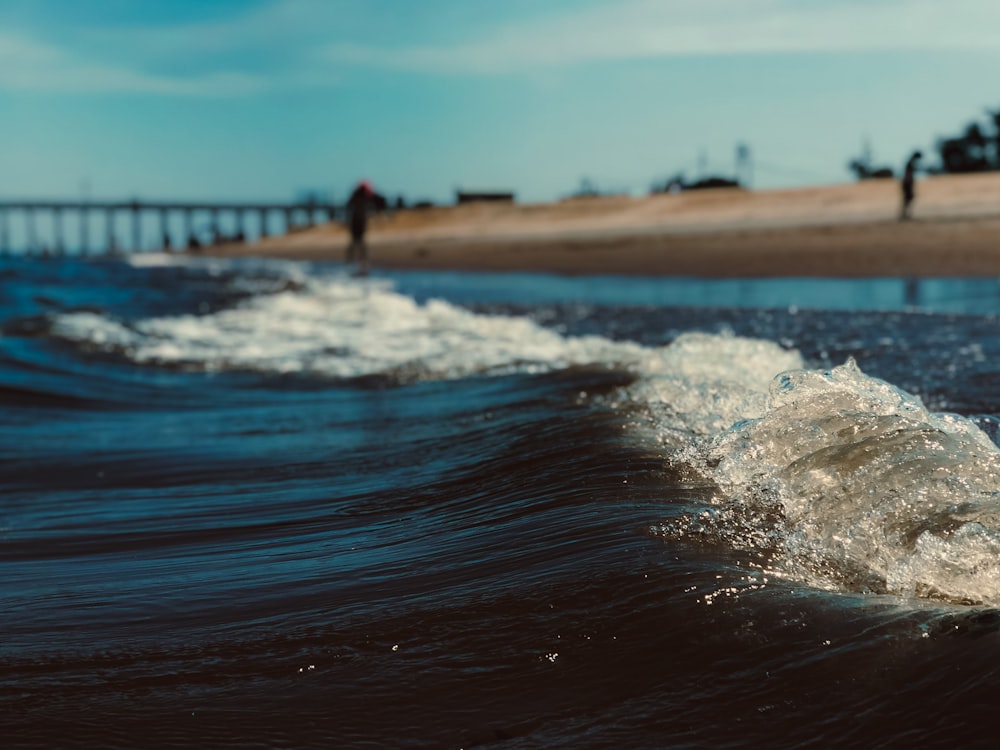 water waves on shore during daytime