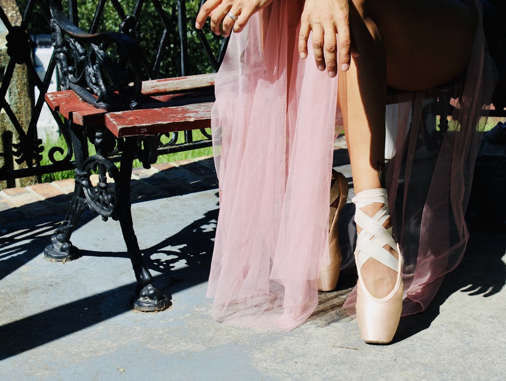 woman in pink dress and white leather peep toe heeled shoes