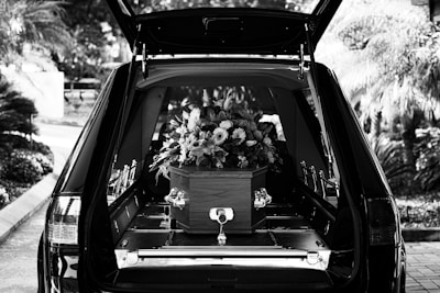 grayscale photo of car with flowers