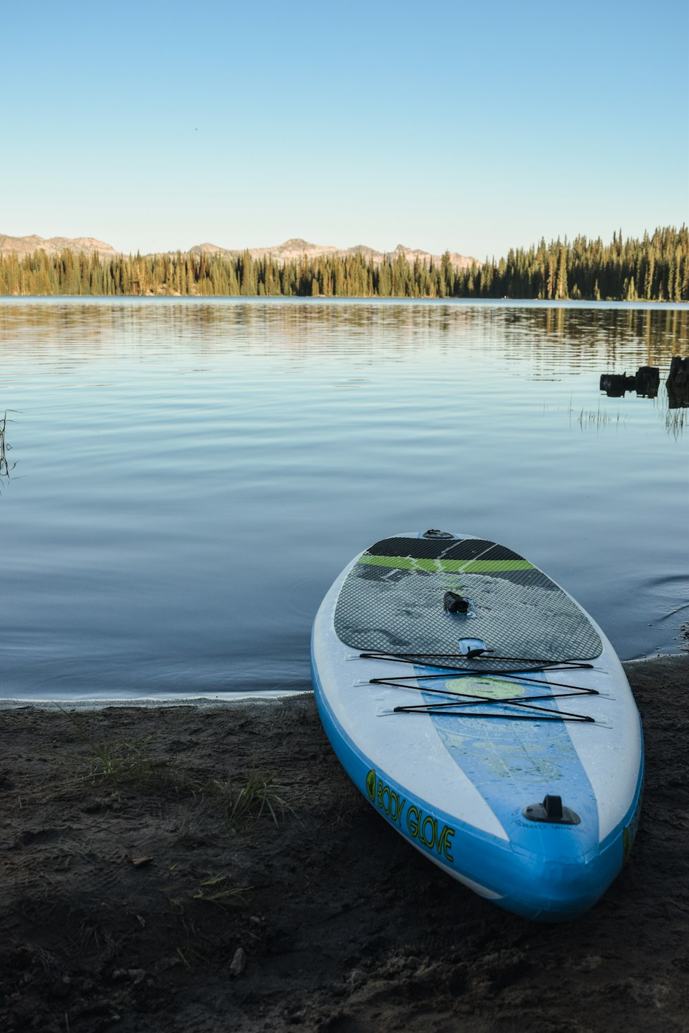 blue and white kayak on lake during daytime