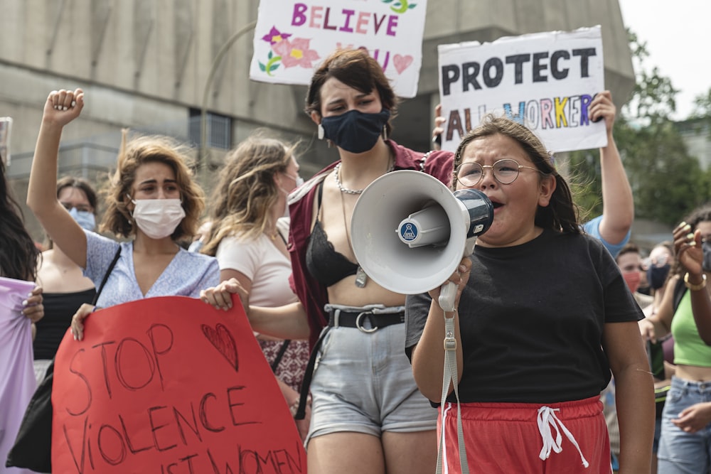 woman in black shirt holding red banner