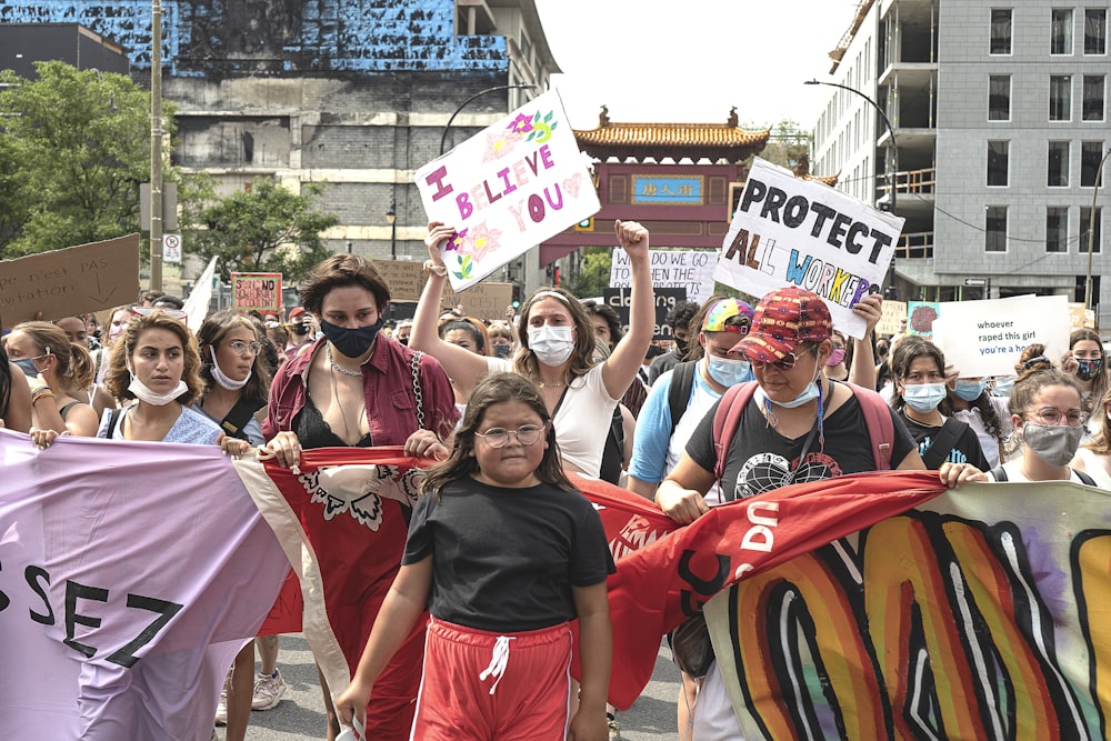 people holding red banner during daytime