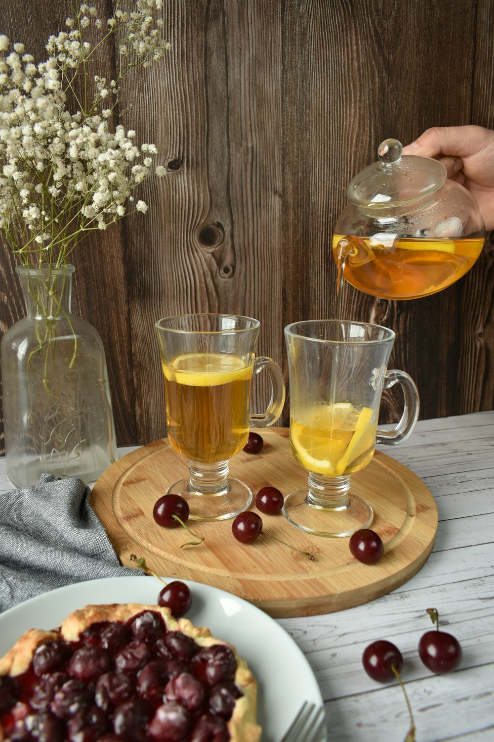 2 clear drinking glasses with yellow liquid