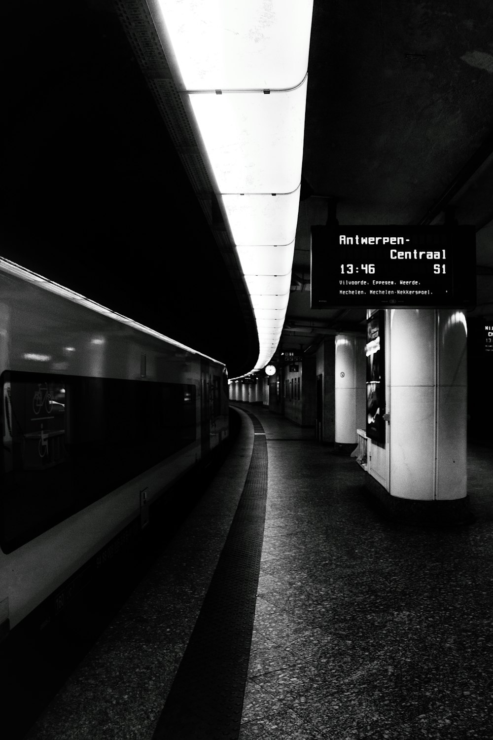 a black and white photo of a subway station