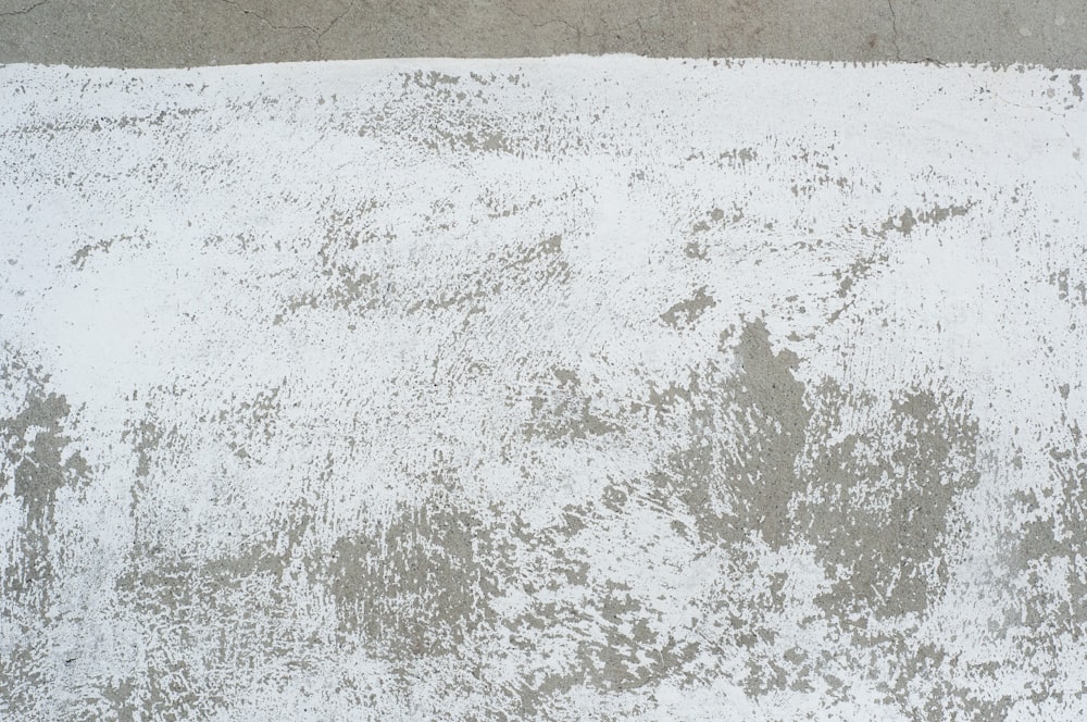 white and brown sand beside body of water